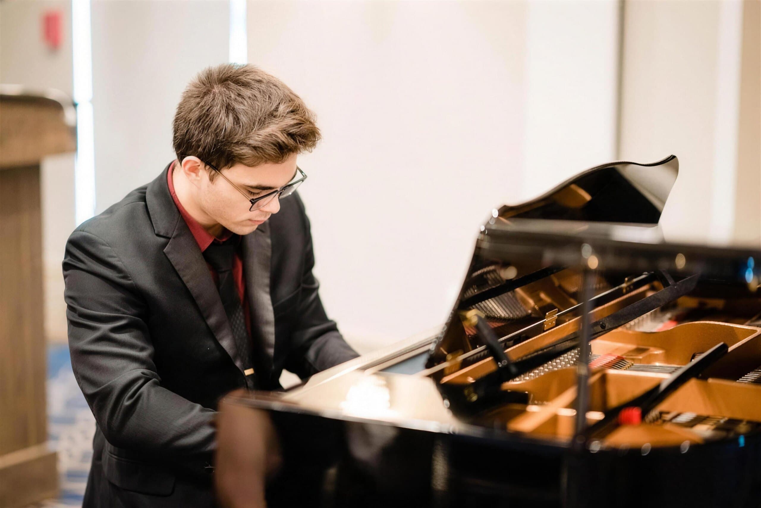 A young Lively Keys student at the grand piano on recital night